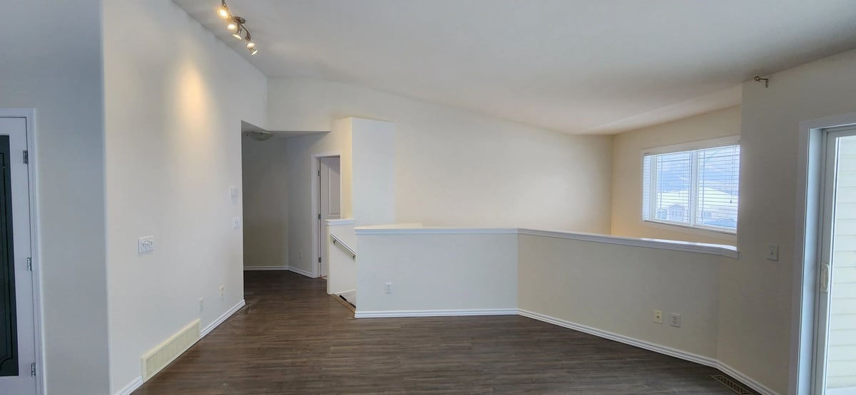 After: Tan walls dotted with patches, finished into a clean white landing and hallway.